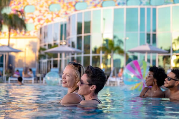 Two couples enjoying the pool at Universal Stella Nova Resort.