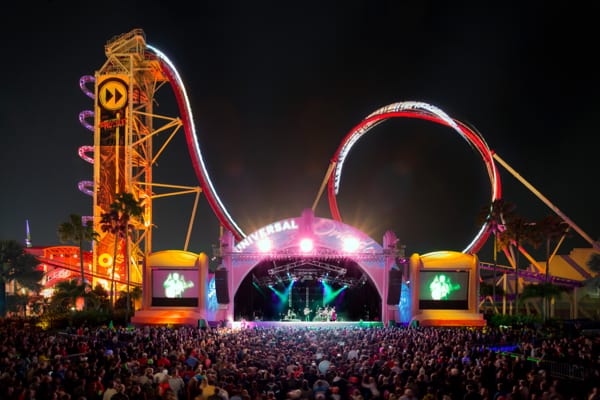 A live nighttime concert with a large crowd at the Music Plaza Stage in Universal Studios Florida.